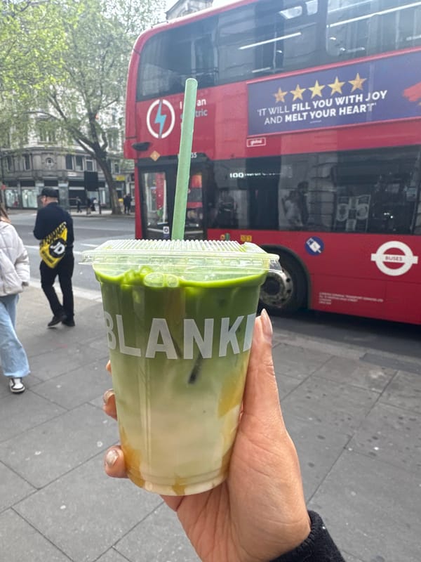 Green tea drink photographed against London double-decker bus backdrop