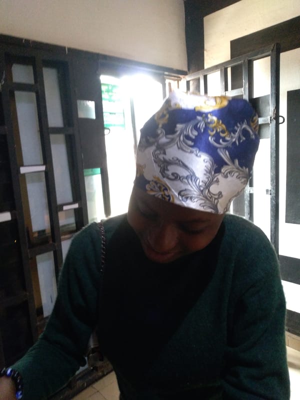 Person in headwrap observed indoors using phone over six minutes