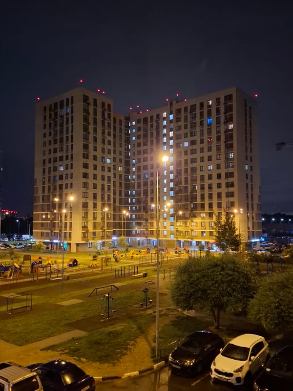 Tall residential complex lit up at night in Balashikha