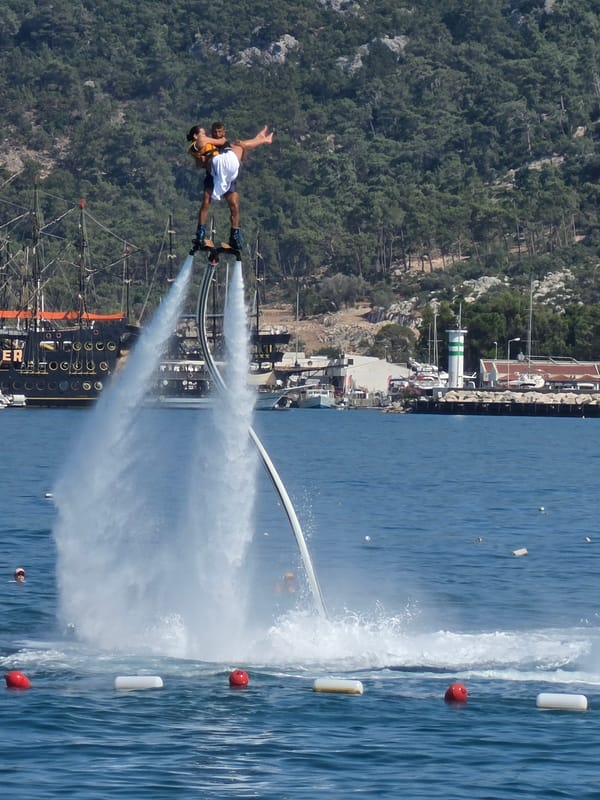 Resort day in Kemer: pool aerobics, flyboarding, and coastal cruising