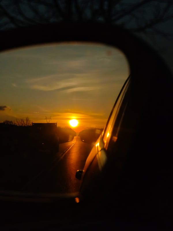 Sunset captured in car mirror during drive in Aksakovo