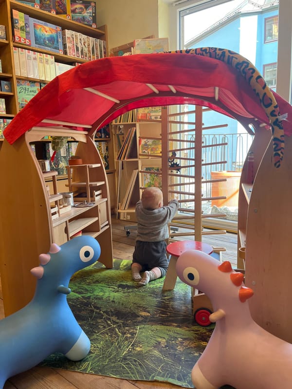 Family explores Munich's Marienplatz with toddler, visits shops and cafes