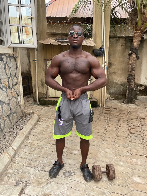 Man poses with sunglasses collection in Akwanga courtyard