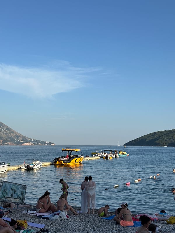Sunny afternoon at Budva's pier and pebble beaches