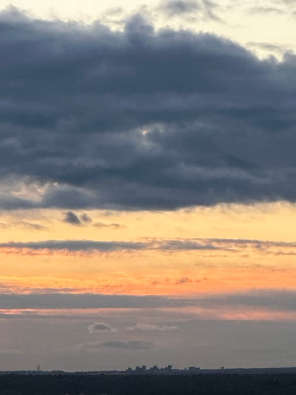 Sunset spreads across Podolsk in warm layers of color