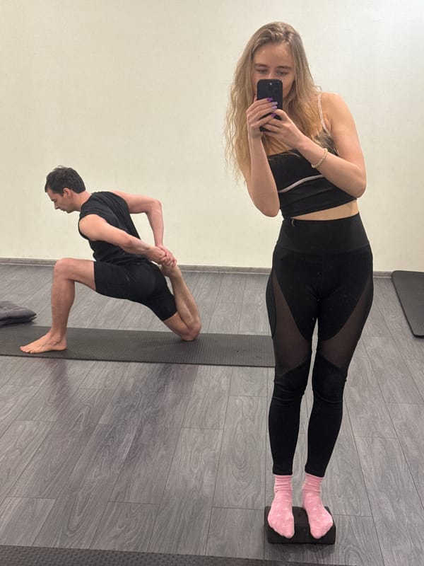 Woman takes gym selfies during partner yoga session