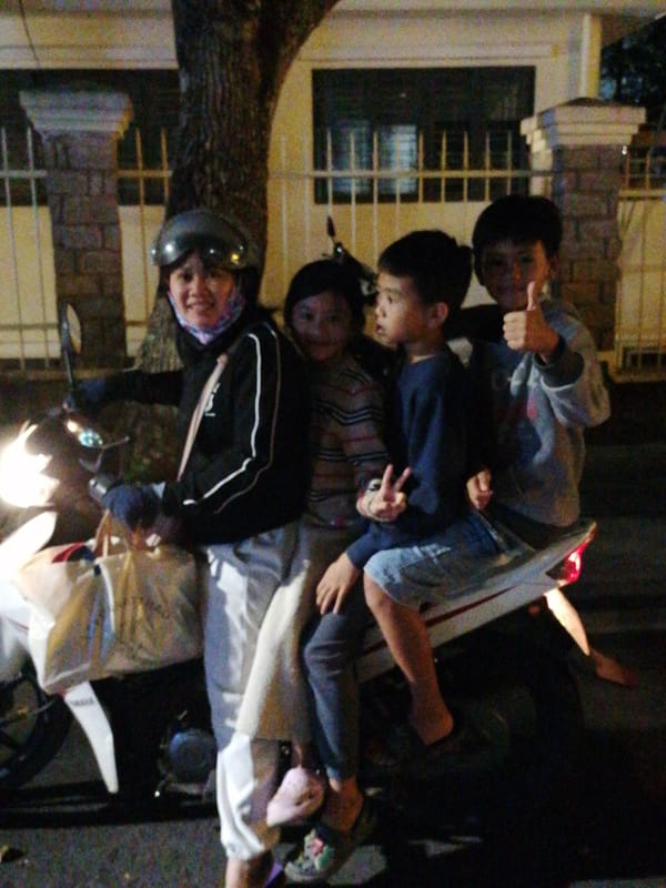 Da Lat streets buzzing with nightlife, scooters, and a public event.