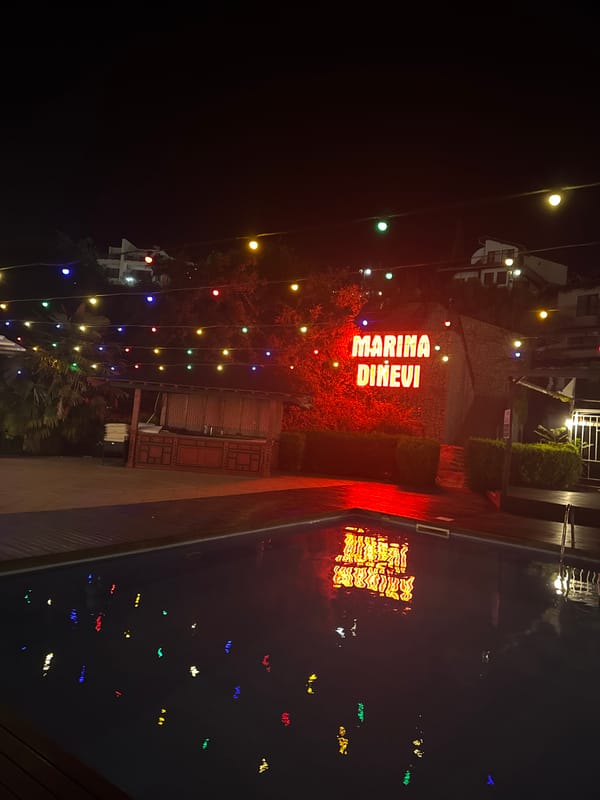 Marina Dinevi at night, neon lights and a vintage Lincoln