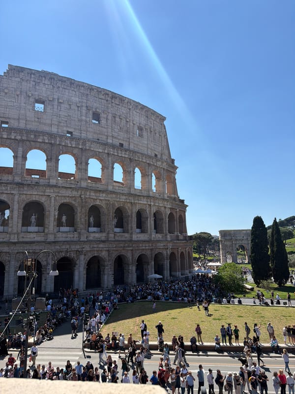 Crowds gather at Rome's Colosseum under clear skies