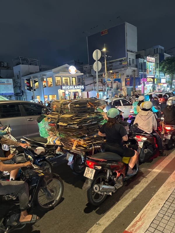 Dense motorbike traffic flows through Thủ Đức streets at night