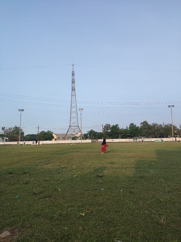 Soccer practice on a Sidokepung grass field on a July morning