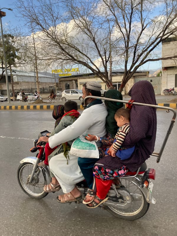 Overloaded motorcycle carries five people in Quetta, Pakistan