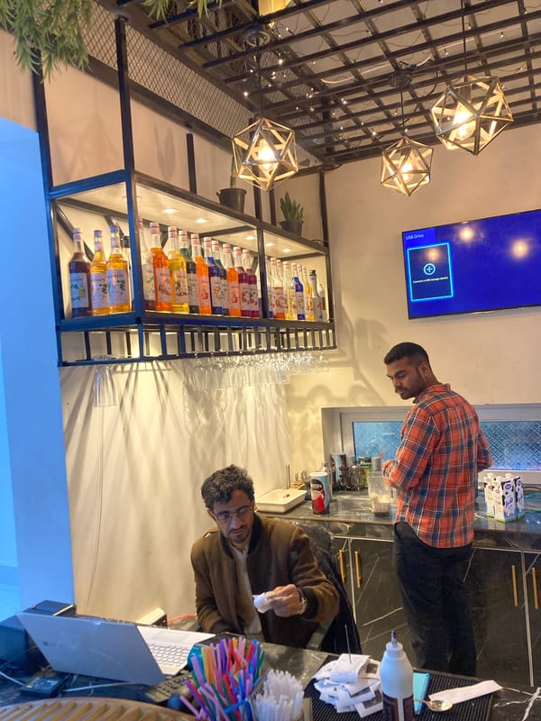 Bartenders prepare drinks at Quetta establishment with flavored syrups