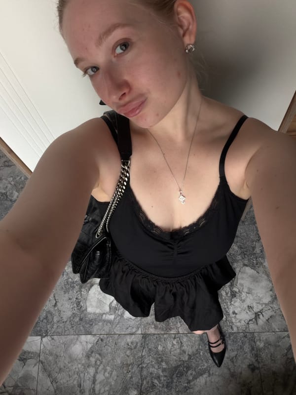 Woman takes mirror selfies in black dress in Russia