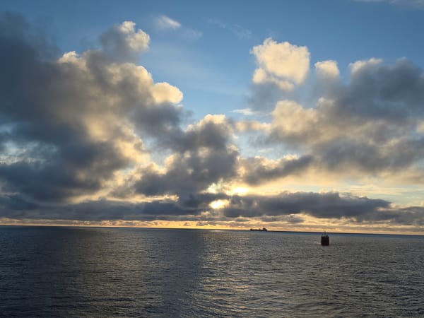 Morning seascape observed in Randaberg with buoy and distant ship