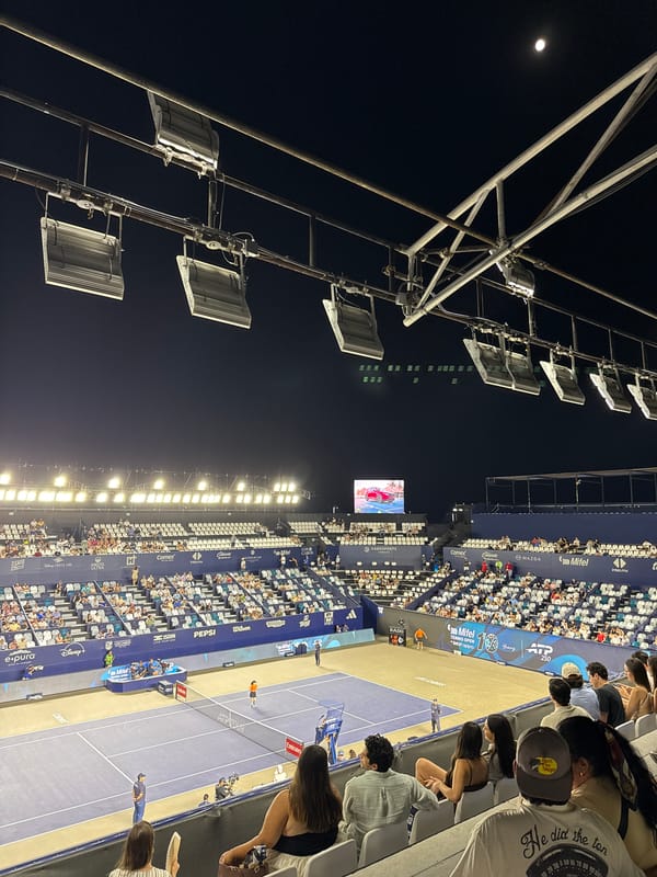 Los Cabos Open stadium glowing under floodlights at night
