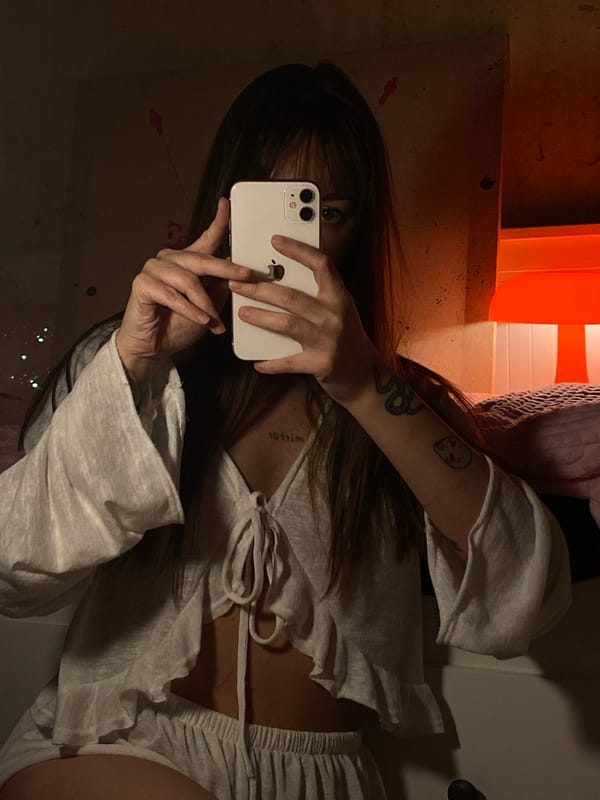 Person takes mirror selfie in cluttered room, Votkinsk