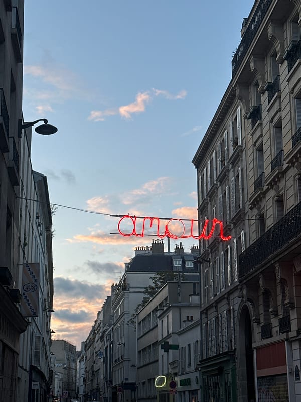 Paris street scenes captured at dusk with neon love sign