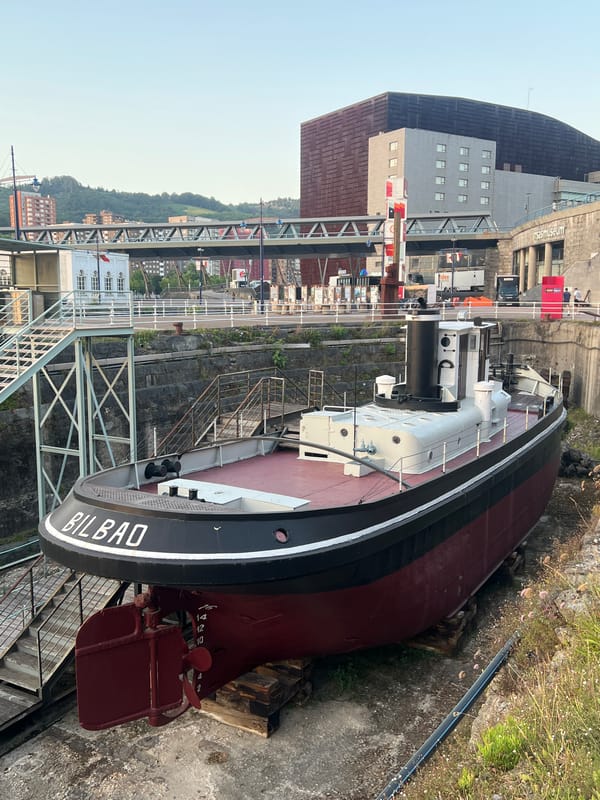Bilbao's waterfront, shipyard, and stadium at golden hour