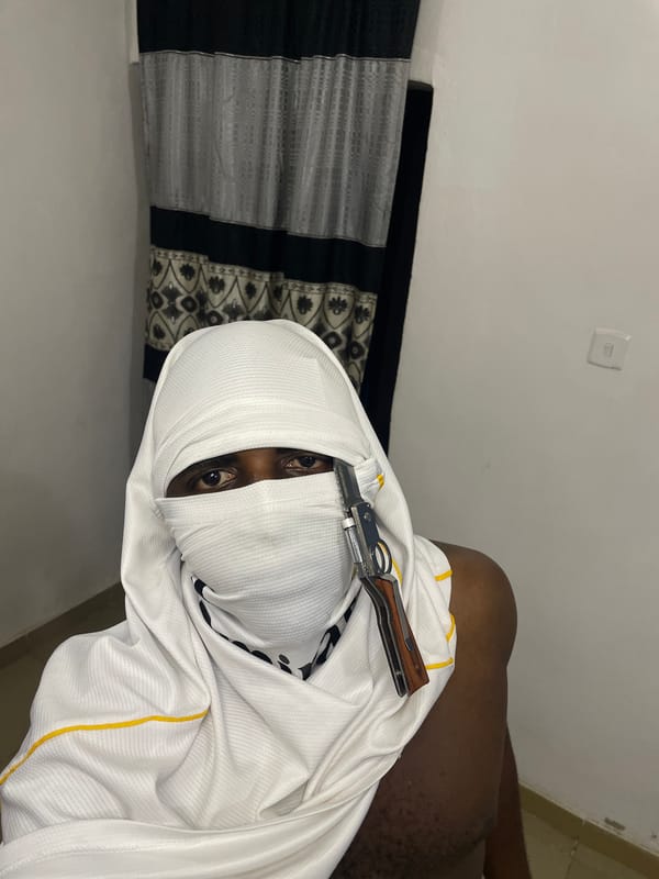 Masked individual photographed with knife in Akwanga residence