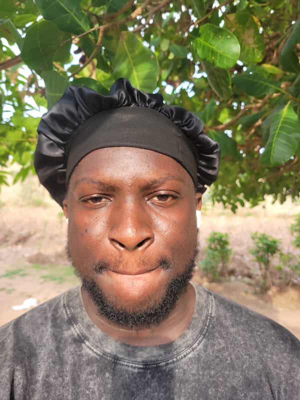 Man in satin bonnet, puppy photographed in Markurdi morning