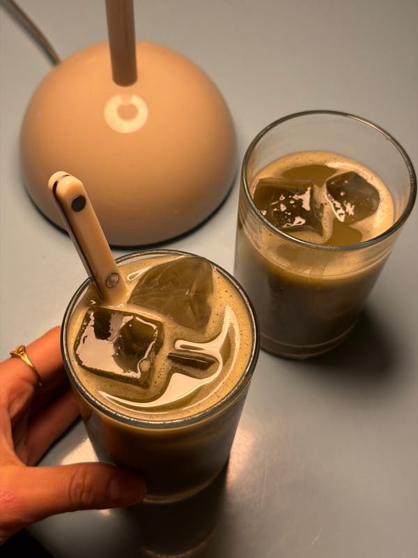 Person enjoys iced beverages in Krasnoyarsk cafe setting