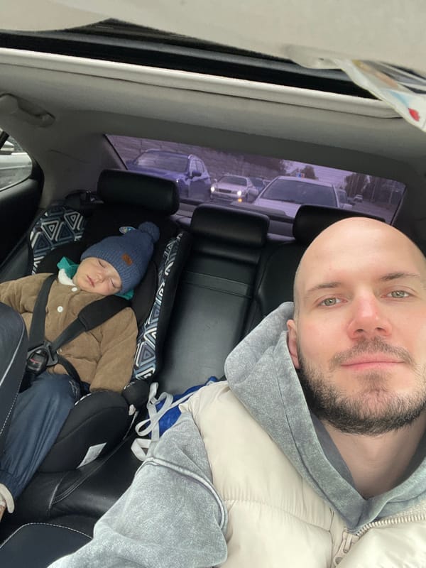 Father and child take selfie in car in Krasnoyarsk
