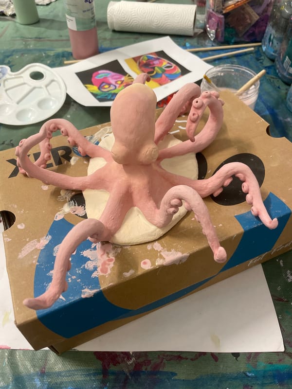 Pink clay octopus sculpture spotted on cardboard box in Raanana