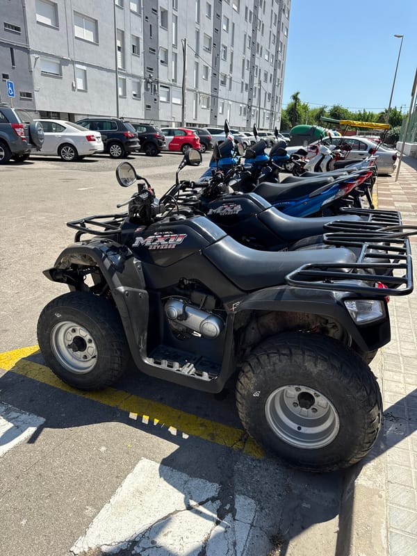 Police presence and rental vehicles on a Blanes summer afternoon