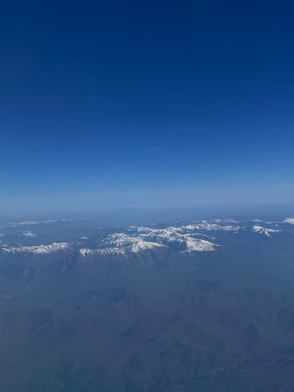 Aerial view captures snow-covered Albanian mountains from airplane