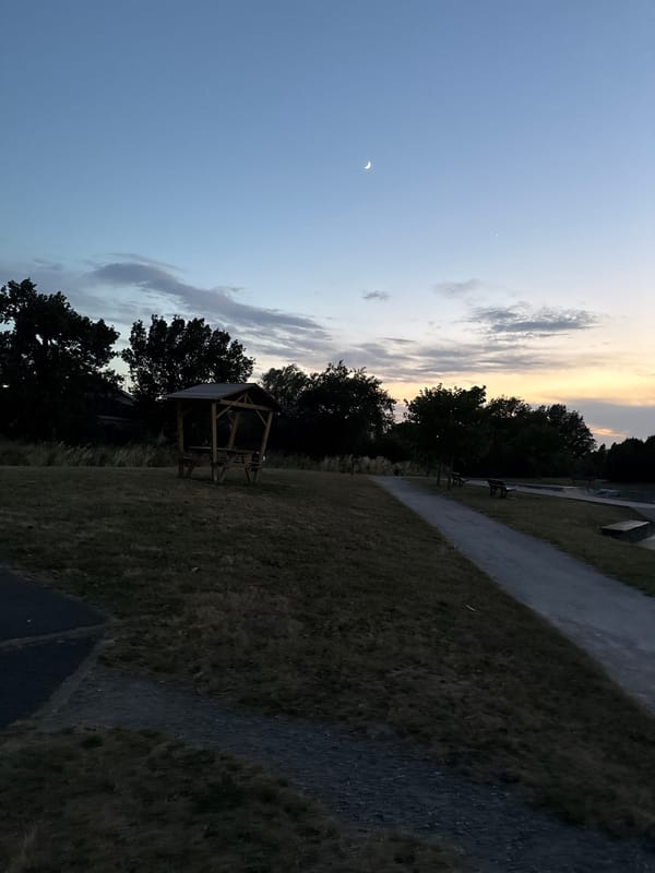 Dusk at a Saint-Orens-de-Gameville park, gazebo and sports fence