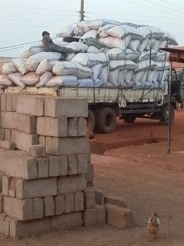 Overloaded truck with resting passenger spotted in Tamale, Ghana