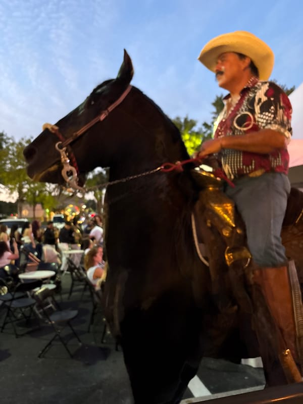 Cowboy spotted riding horse through unidentified city streets