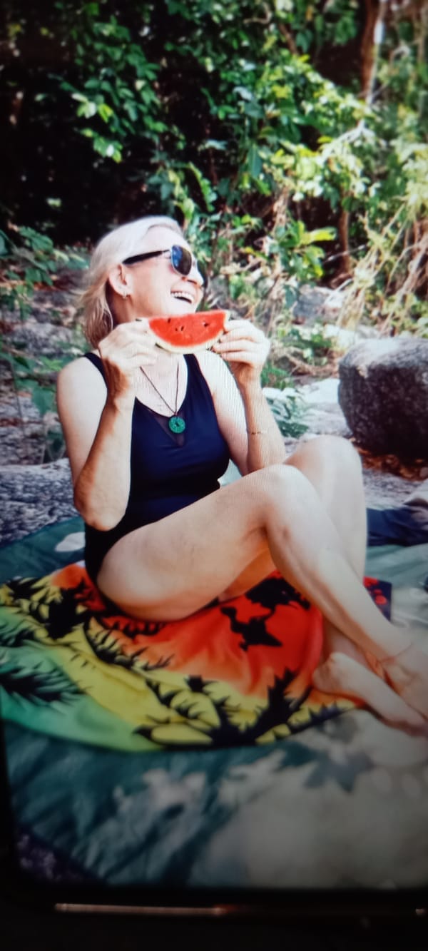 Woman enjoys tropical relaxation with watermelon in Thailand