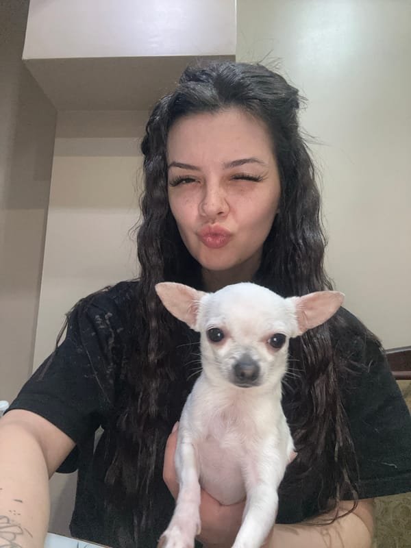 Woman takes selfies with small dog in Sliven apartment