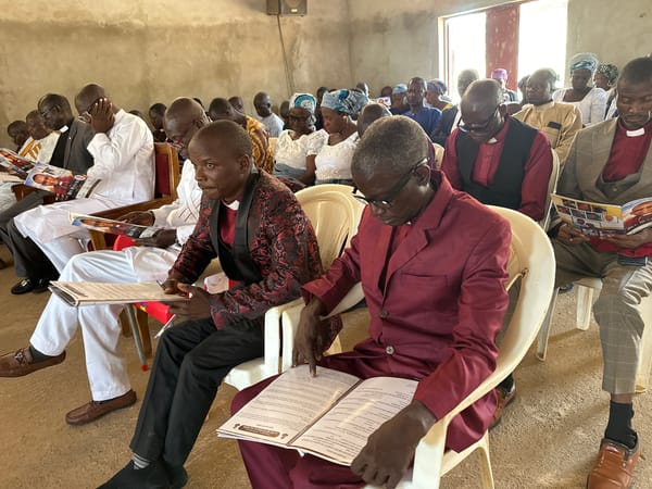 Funeral service with clergy and brass band in Kufana, Nigeria