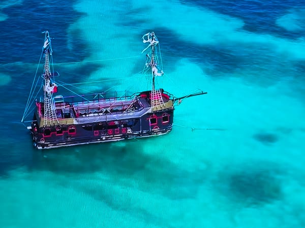 Pirate-style vessel spotted anchored in turquoise waters
