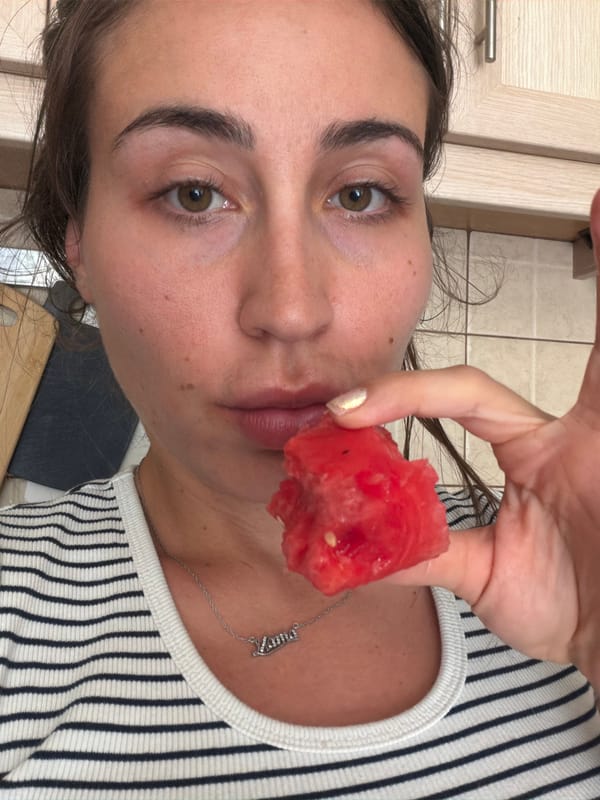 Woman enjoys watermelon snack in Tersefanou kitchen