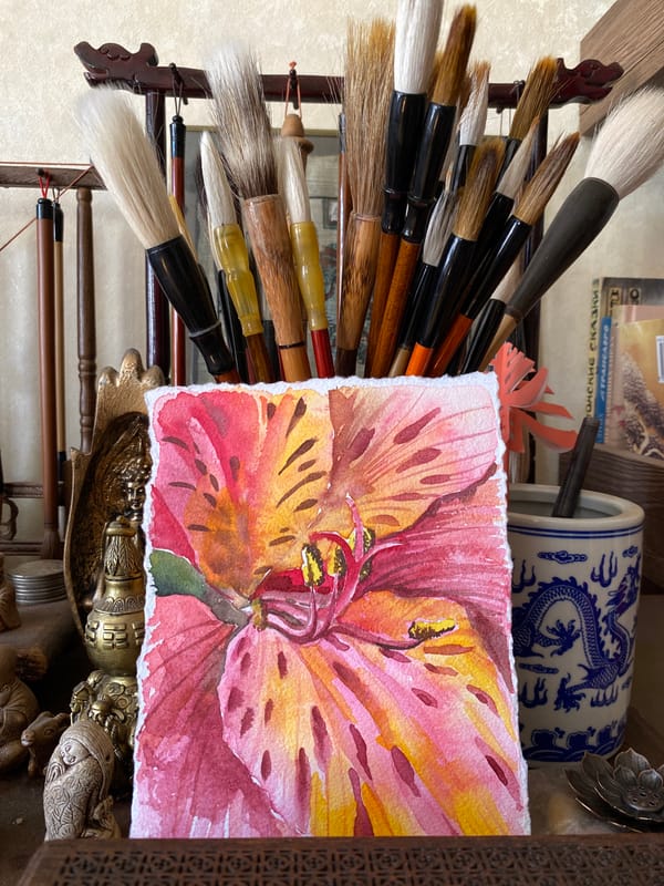 Artist workspace documented in Izhevsk showing brushes, painting, Santa hat