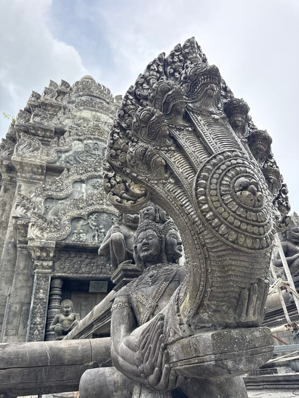 Detailed stone carvings and mythological statues at a Thai temple