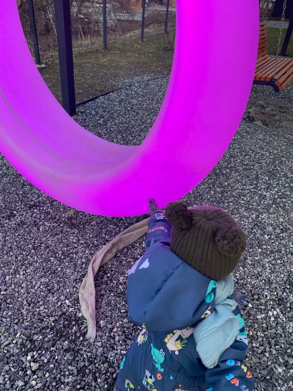 Child plays with colorful rings in Izhevsk outdoor area