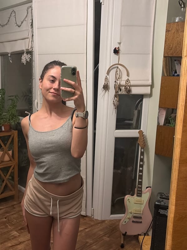Mirror selfies and a relaxed cat on a wooden floor