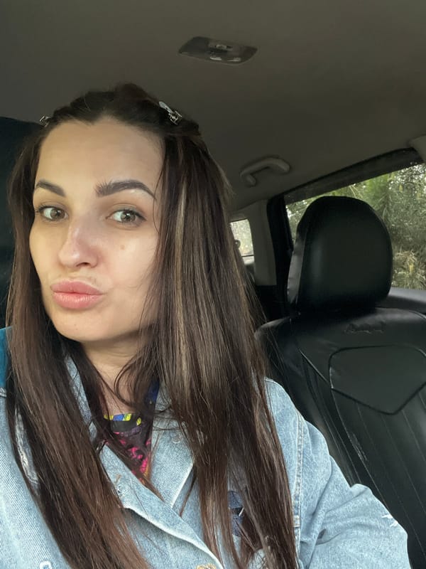 Woman takes car selfies in blue denim jacket