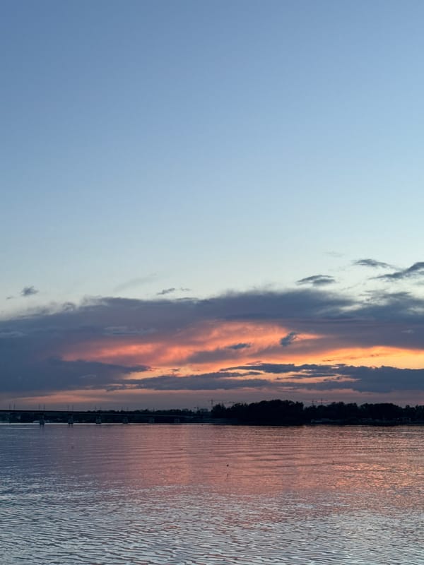 Sunset documented along Perm waterfront with urban landmarks