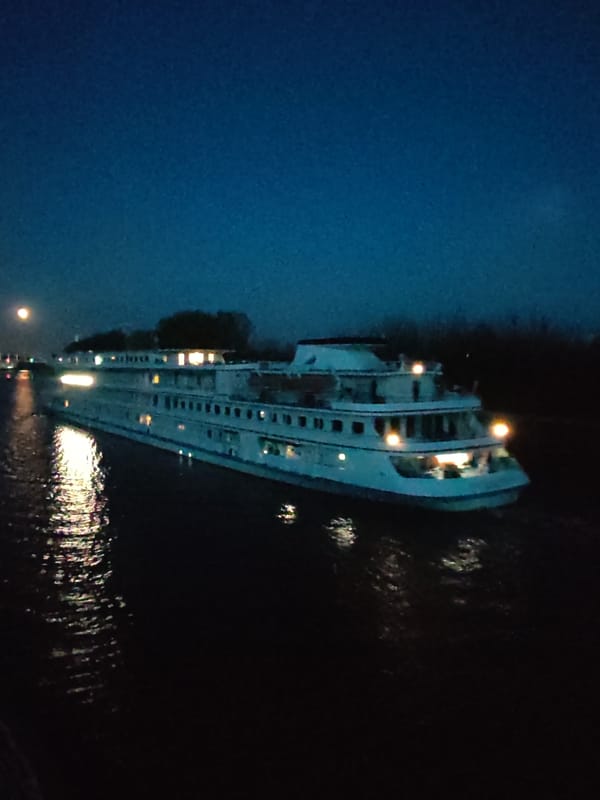 Cruise ship travels dark river near Dmitrov at night