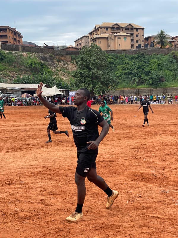Amateur soccer match played on dirt field draws spectators