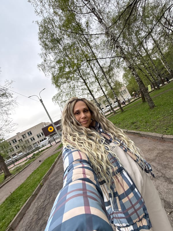 Woman with curled blond hair photographed from below angle