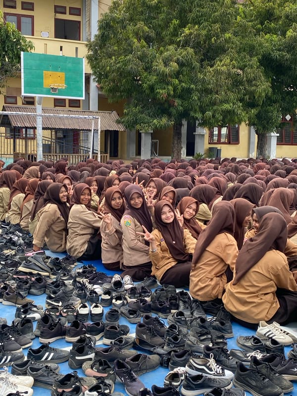 School assembly on a blue court, students in uniform