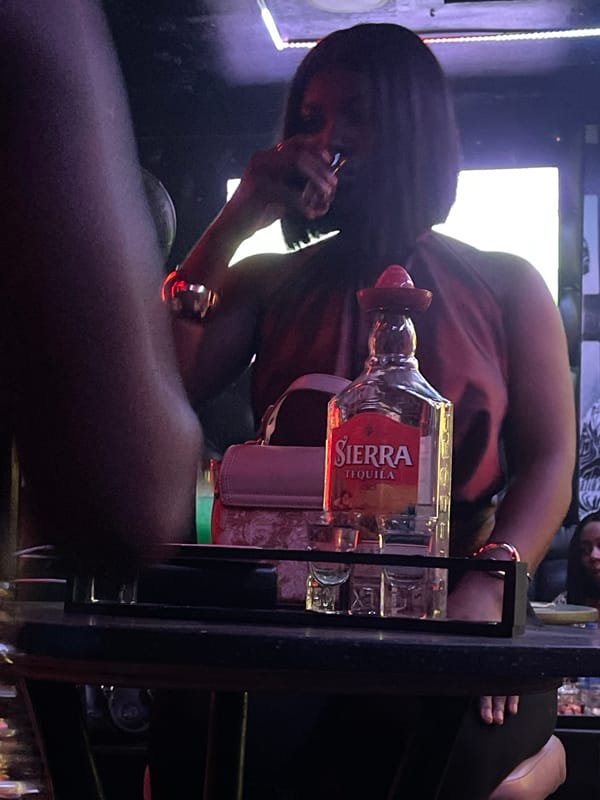 Bar patron takes phone call over tequila in Nigeria