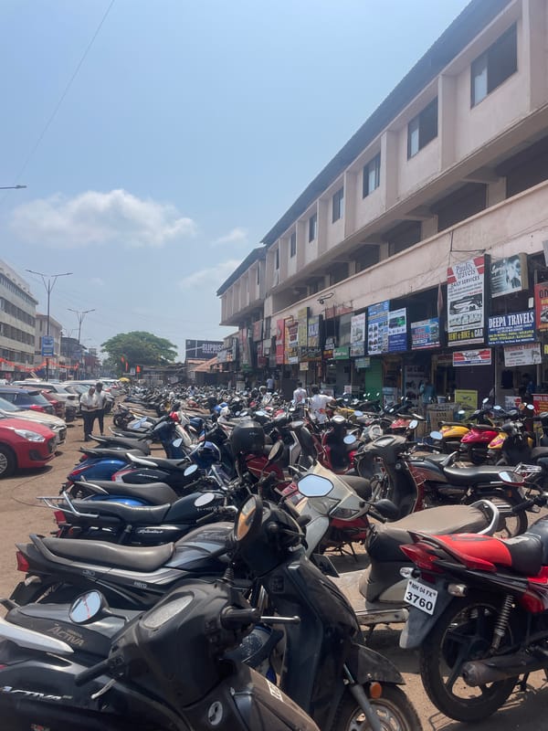Motorbikes crowd street scene in Mapusa, India